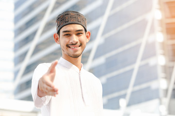 Muaslim emirates man ready to handshake outdoor in city background