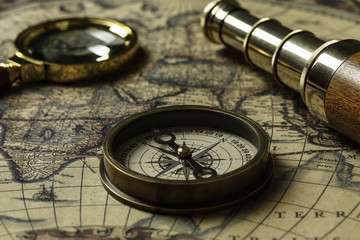 Retro compass with old map and spyglass