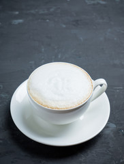 Cup of coffee on the rustic wooden background. Selective focus. Shallow depth of field.