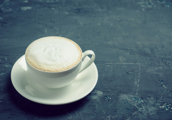 Cup of coffee on the rustic wooden background. Selective focus. Shallow depth of field.