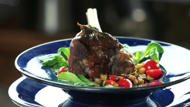 Lamb shank and ratatouille. Cooked meat with vegetables.