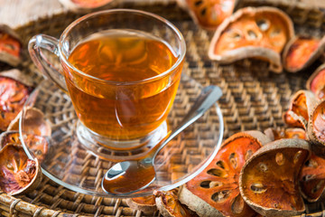 Bael tea juice on wooden table , healthy drink