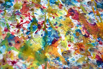 Blurred watercolor painting abstract background in green, blue, golden and violet hues and colors