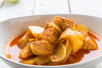 Massaman pork curry on wood background. Coconut milk curry.