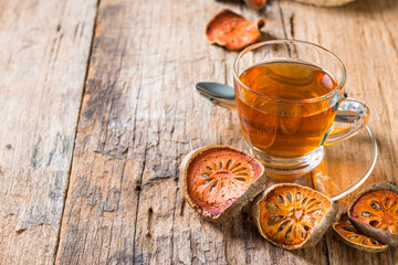 Bael tea juice on wooden table , healthy drink