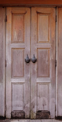 Thai style door handles on old wooden door 