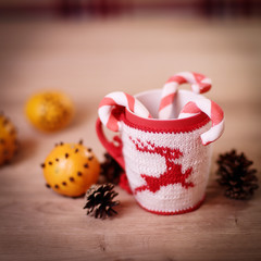 Christmas Cup and oranges on wooden background blurred.