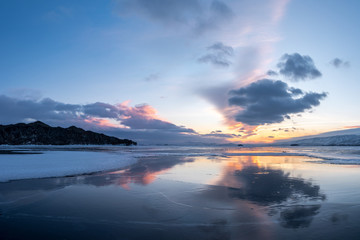Reflection of clouds in clear ice of Lake Baikal