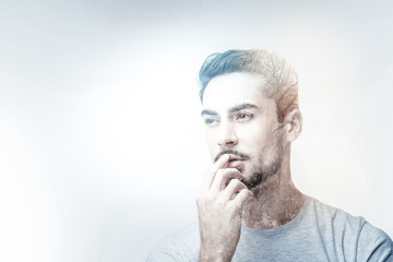 Seriousness. Concentrated brunette turning head and looking aside while putting finger on his lips