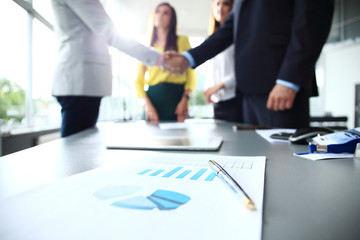 Business people shaking hands, finishing up a meeting.