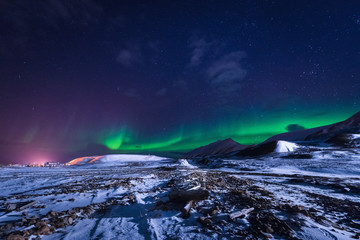 Fototapeta na wymiar The polar arctic Northern lights aurora borealis sky star in Norway Svalbard in Longyearbyen city town mountains