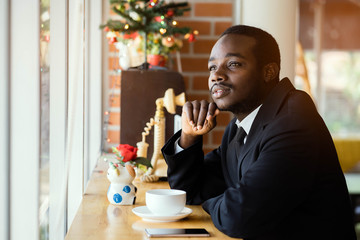 African business man thinking in the cafe or coffee shop.