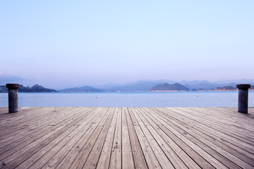 empty wooden floor with beautiful lake
