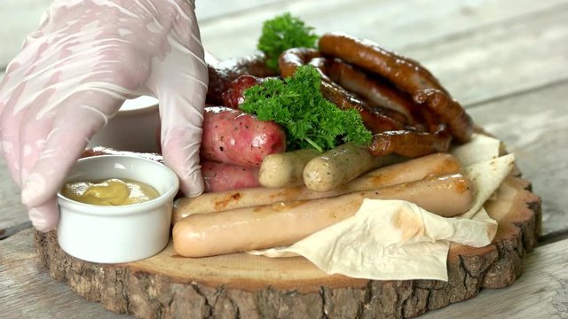Grilled sausages with sauce. Food on wooden board.
