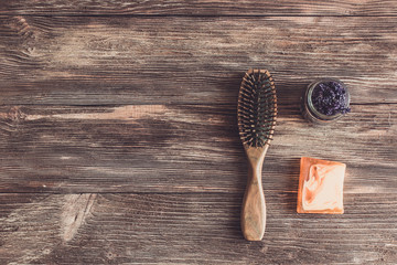 Haircare concept. Natural sandalwood comb closeup on wood background