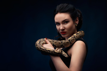 Close up portrait of woman with snake on her neck