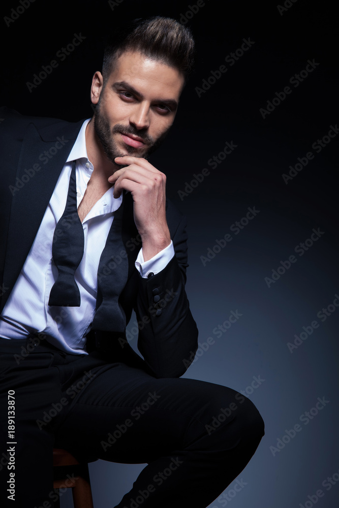 Canvas Prints man in tuxedo with untied bowtie is smiling and thinking