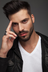 young man with fingers on temple giving military salute