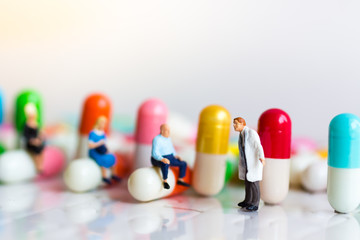 Miniature people: Group people queue up to wait for the doctor. Image use for Health check concept.