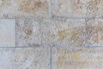 Old stone wall of a castle made of chalkstone