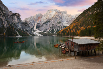 Wooden chalet and boats at the Alpine mountain lake
