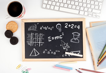 math formulas, education and knowledge concept. Chalkboard on white office desk.