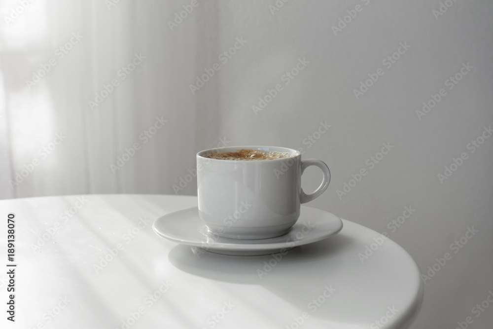 Wall mural cup of coffee on white table