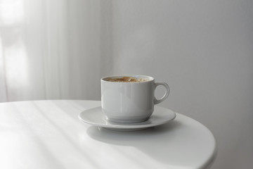 cup of coffee on white table