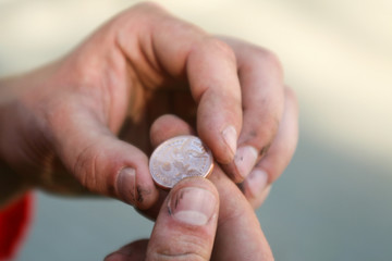 wedding coin for good luck in the hands of male workers