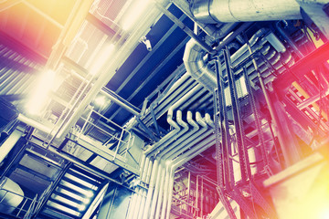 Equipment, cables and piping as found inside of a modern industrial power plant