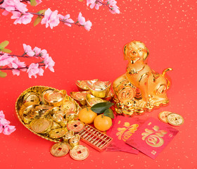 Chinese new year decoration:golden dog statue and gold ingots,translation of calligraphy: good Fortune for year