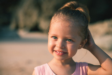 Beautiful little girl at the beach. Sunblock cream for children.