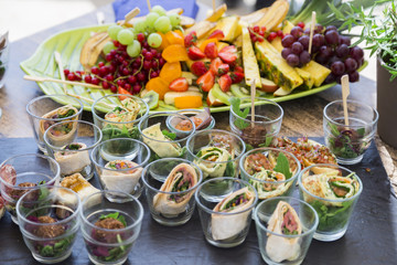 Bruschetta with vegetables, pancakes with salmon, fresh fruits
