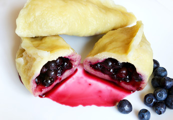 Dumpling with berries fresh blueberries on a white plate.Organic, natural, eco-friendly food.