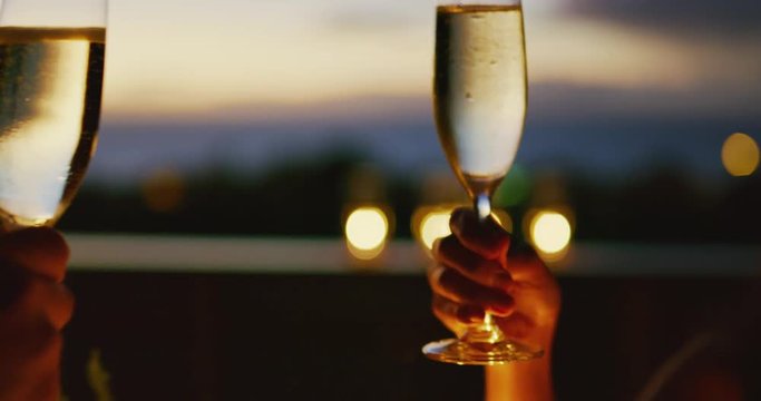 Couple celebrating drinking champagne at sunset