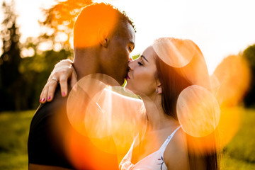 Mixed race couple kissing outdoor