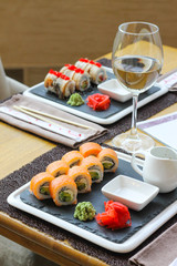 Uramaki rolls with a glass of white wine - restaurant serve