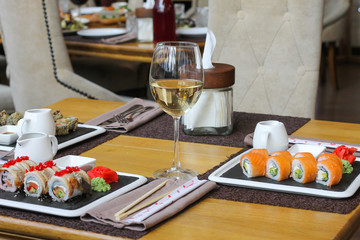 Uramaki rolls with a glass of white wine - restaurant serve