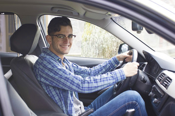 young adult driving the car