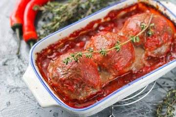 Baked meatballs from beef in tomato sauce with thyme