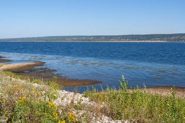 Shallow shore of Volga river on summer morning.