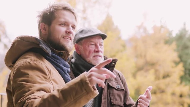 Senior father and his young son on a walk.