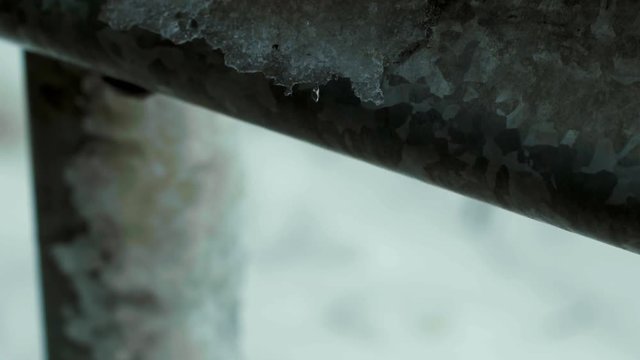 icicle on road barrier breaks falls off slomo