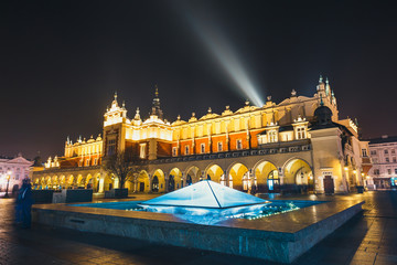 Fototapeta na wymiar Cloth Hall building and fountain at night on main square of Krakow city, Poland