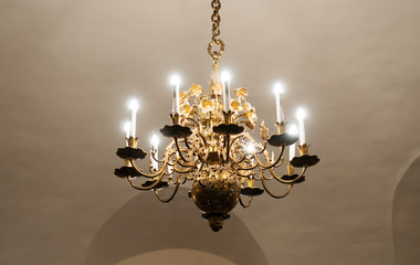 Ancient gilded chandelier in the castle.
