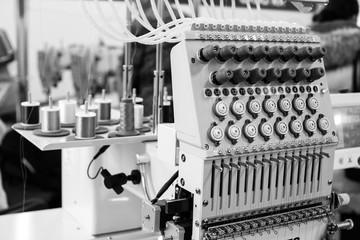 Industrial sewing machine close-up, monochrome
