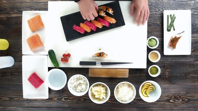 Cooking table, sushi. Hands of chef, japanese dish.