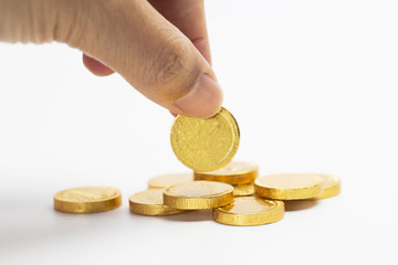 Hand picking up one gold coin