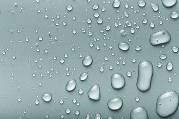Drops of water on a color background. Gray. Toned