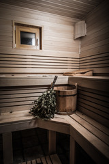 Equipment for sauna in light wooden cozy interior. Toned